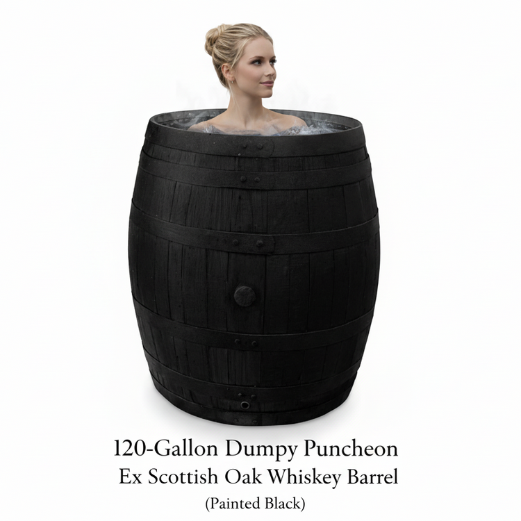 Person in a large black oak barrel ice bath for cold water therapy and cold water plunge